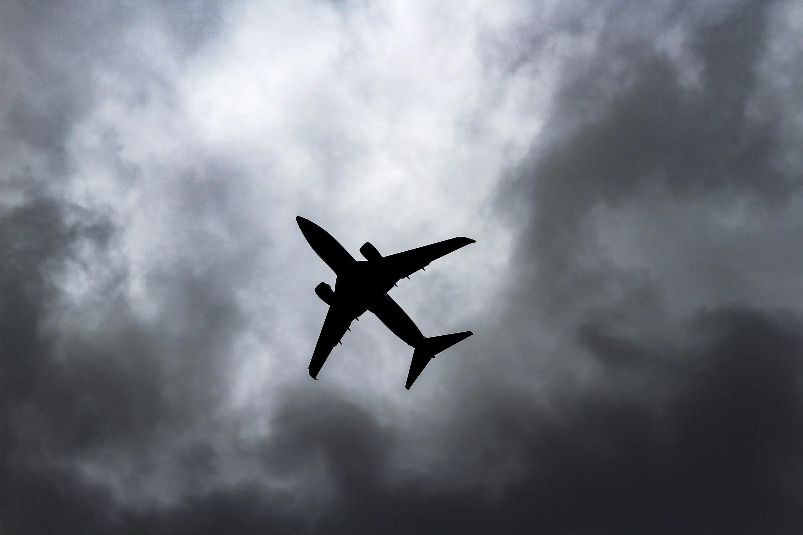 passenger plane under white clouds
